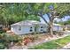 An angled exterior view shows the home, garage and mature landscaping at 613 Sportsman Park Dr, Seffner, FL 33584