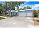 Beautiful blue single Gathering home with a meticulously landscaped front yard and an attached two-car garage at 613 Sportsman Park Dr, Seffner, FL 33584