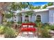 Charming front yard with mature landscaping and a cozy red bench at 613 Sportsman Park Dr, Seffner, FL 33584