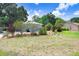 Lush front yard features mature trees, manicured shrubbery, and well-maintained landscaping at 613 Sportsman Park Dr, Seffner, FL 33584