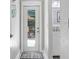 Hallway with a mirrored door and a view to a back yard patio through a glass door at 613 Sportsman Park Dr, Seffner, FL 33584