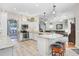 Open kitchen with stainless steel appliances, an island with seating, and an adjoining living area at 613 Sportsman Park Dr, Seffner, FL 33584