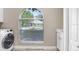 Well lit laundry room with a large window providing ample natural light at 613 Sportsman Park Dr, Seffner, FL 33584