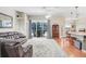Comfortable living room area featuring hardwood floors, neutral tones, and access to the pool at 613 Sportsman Park Dr, Seffner, FL 33584