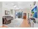 Spacious living room featuring a leather sofa, ceiling fans, and sliding glass doors to the pool area at 613 Sportsman Park Dr, Seffner, FL 33584