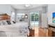 Main bedroom with hardwood floors, view of pool and patio, tray ceilings, and a walk-in closet at 613 Sportsman Park Dr, Seffner, FL 33584