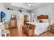Main bedroom featuring tray ceiling, wood floors, and ensuite bathroom entrance at 613 Sportsman Park Dr, Seffner, FL 33584