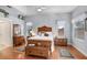 Bright main bedroom featuring tray ceiling, two windows, and hardwood floors at 613 Sportsman Park Dr, Seffner, FL 33584