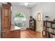 Home office with hardwood floors, built-in bookshelves, and a large window at 613 Sportsman Park Dr, Seffner, FL 33584