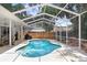Inviting backyard pool with screened enclosure, perfect for outdoor relaxation and entertainment at 613 Sportsman Park Dr, Seffner, FL 33584