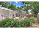 View of the screened-in patio with dining set, plus lush landscaping and access to the refreshing swimming pool at 613 Sportsman Park Dr, Seffner, FL 33584