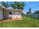Charming backyard featuring a shed, lush green grass and mature landscaping at 6282 41St N Ave, St Petersburg, FL 33709