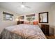 Bright bedroom with neutral walls, windows, and ceiling fan at 6282 41St N Ave, St Petersburg, FL 33709