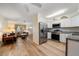 Well-lit kitchen with stainless steel appliances, white cabinetry, and hardwood floors at 6282 41St N Ave, St Petersburg, FL 33709