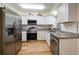 Modern kitchen featuring granite countertops, stainless steel appliances, and white cabinetry at 6282 41St N Ave, St Petersburg, FL 33709