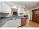 A kitchen with stainless steel appliances, granite countertops, and white cabinets at 6282 41St N Ave, St Petersburg, FL 33709