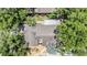 Aerial shot showing the top of this house with a brown roof and green trees all around the property at 660 Channing Dr, Palm Harbor, FL 34684