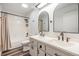 Bathroom featuring double sink vanity with dark fixtures, tile flooring, and shower-tub combo at 660 Channing Dr, Palm Harbor, FL 34684