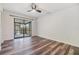 Bedroom with wood flooring and sliding glass doors to screened porch at 660 Channing Dr, Palm Harbor, FL 34684