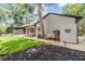Charming home with a blue front door, well-maintained lawn, and lovely landscaping at 660 Channing Dr, Palm Harbor, FL 34684