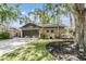 Attractive home with a manicured lawn, beautiful landscaping, and a welcoming entryway at 660 Channing Dr, Palm Harbor, FL 34684