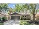 Charming single-story home with a well-manicured lawn and mature landscaping, featuring a two-car garage at 660 Channing Dr, Palm Harbor, FL 34684