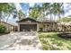 Well-maintained home with a spacious driveway, garage, and lovely landscaping at 660 Channing Dr, Palm Harbor, FL 34684