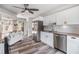 Modern kitchen with white cabinetry, granite countertops, stainless steel appliances, and stylish backsplash at 660 Channing Dr, Palm Harbor, FL 34684