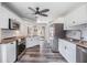Updated kitchen features white cabinets, stainless steel appliances, granite countertops, and modern fixtures at 660 Channing Dr, Palm Harbor, FL 34684