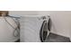 Modern laundry room featuring a side-by-side washer and dryer for convenient laundry days at 660 Channing Dr, Palm Harbor, FL 34684