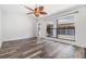 Spacious living room with wood flooring, ceiling fan, and large window at 660 Channing Dr, Palm Harbor, FL 34684