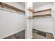 Walk-in closet featuring wood shelving, wood racks, and multi-patterned carpet at 660 Channing Dr, Palm Harbor, FL 34684