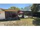 Spacious backyard featuring a screened lanai and pool at 7700 Willow Brook Ct, Hudson, FL 34667