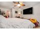 Bedroom with white walls, wood floors, and a large television creating a cozy space at 7700 Willow Brook Ct, Hudson, FL 34667