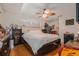 Comfortable bedroom featuring hardwood floors and a unique ceiling fan with natural light at 7700 Willow Brook Ct, Hudson, FL 34667