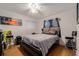 Bedroom featuring hardwood floors, white walls, and an abundance of natural light at 7700 Willow Brook Ct, Hudson, FL 34667