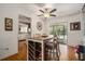 Bright dining area with a modern table, wood floors, and access to the outdoors at 7700 Willow Brook Ct, Hudson, FL 34667