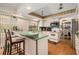 Charming kitchen with white cabinets, green countertops, and modern appliances at 7700 Willow Brook Ct, Hudson, FL 34667