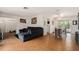 Open-concept living and dining area with wood floors and a comfortable gray sectional sofa at 7700 Willow Brook Ct, Hudson, FL 34667