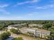 Aerial view showcasing large multi-Gathering residential buildings surrounded by green trees under a clear blue sky at 909 E 15Th Ave, Tampa, FL 33605