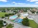 Aerial shot of recreation center including an outdoor pool, tennis courts, and surrounding neighborhood at 909 E 15Th Ave, Tampa, FL 33605