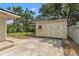Practical backyard shed providing extra storage space and featuring a secure door at 909 E 15Th Ave, Tampa, FL 33605