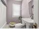 Bathroom featuring lavender walls, shower, white vanity, and natural light at 909 E 15Th Ave, Tampa, FL 33605