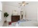 Bedroom featuring neutral decor, ceiling fan, ample natural light, and a classic dresser at 909 E 15Th Ave, Tampa, FL 33605