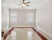 Bright bedroom featuring neutral decor, ceiling fan, and natural light from multiple windows at 909 E 15Th Ave, Tampa, FL 33605