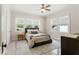 Inviting bedroom with ceiling fan, neutral decor, area rug, and natural light at 909 E 15Th Ave, Tampa, FL 33605