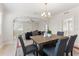 Open dining area with modern lighting, and a view into the living room at 909 E 15Th Ave, Tampa, FL 33605