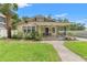 Charming single-story home features a well-manicured lawn and lovely landscaping at 909 E 15Th Ave, Tampa, FL 33605