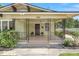 Inviting front porch boasts decorative iron railings and a cozy entrance at 909 E 15Th Ave, Tampa, FL 33605