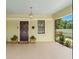 Charming covered front porch, featuring a dark wood door and decorative plants at 909 E 15Th Ave, Tampa, FL 33605